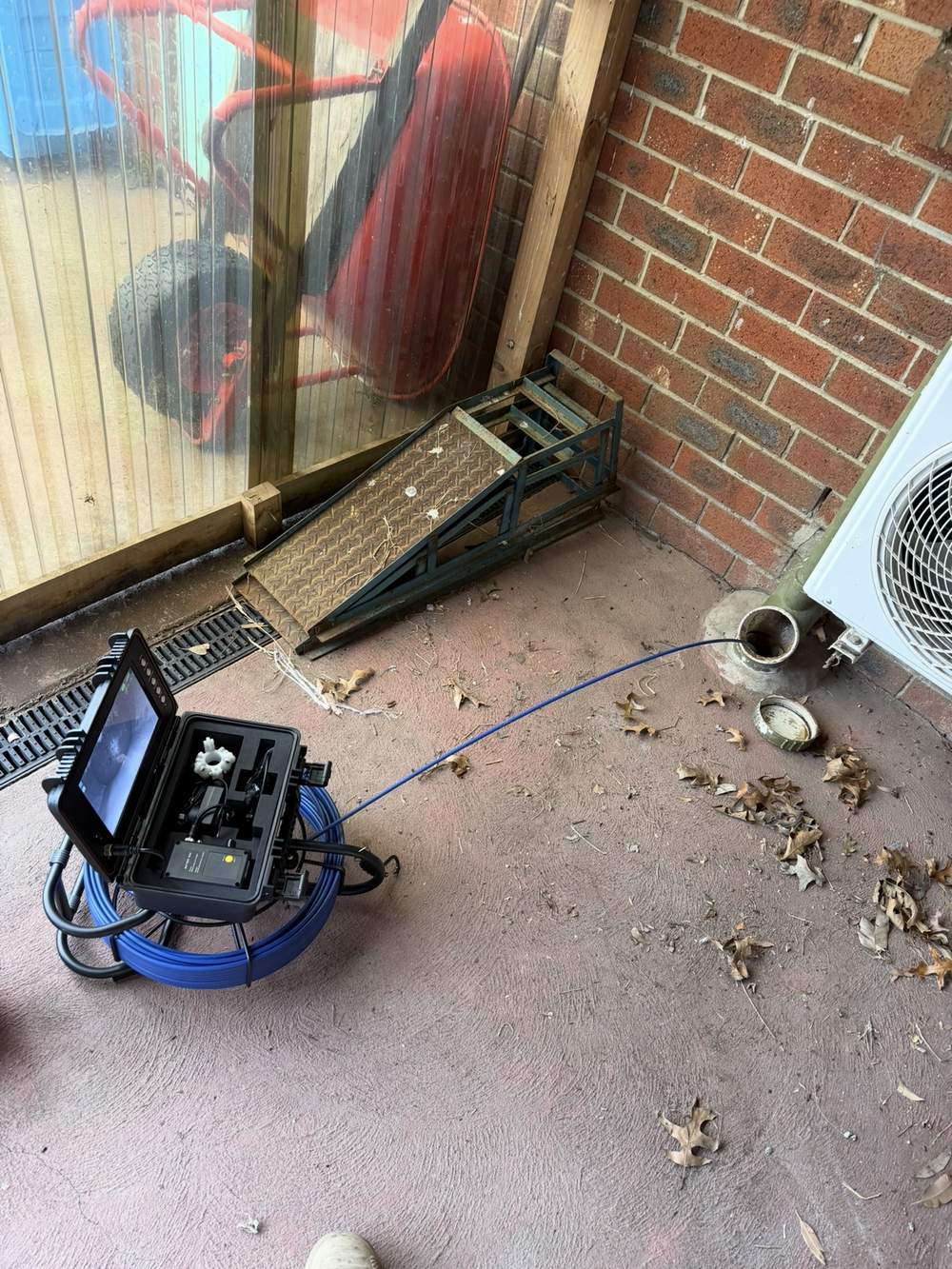 Hydro jetting and CCTV drain camera equipment set up at a sewer access point in Berwick